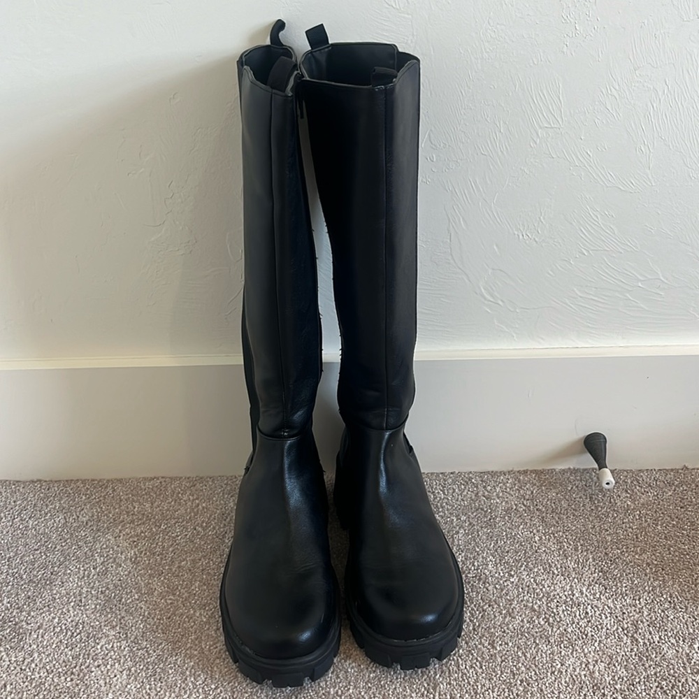 Black faux leather tall zip up chunky boots.